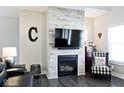 Cozy living room featuring a stone accent wall with a fireplace, creating a warm and inviting atmosphere at 217 N Liberty Blvd, Mooresville, IN 46158