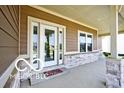 Inviting covered porch with stone accents, offering a pleasant outdoor space and a glimpse of the home's curb appeal at 217 N Liberty Blvd, Mooresville, IN 46158