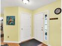 Bright foyer featuring wood floors, a coat closet, and neutral-colored walls at 2623 Senators Way, Indianapolis, IN 46217
