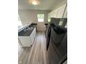 Modern kitchen boasting white cabinets, black countertops, and stainless-steel appliances at 2717 N Rural St, Indianapolis, IN 46218