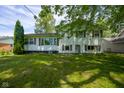 A spacious backyard features a well-maintained lawn and mature tree coverage at 2721 W 34Th St, Anderson, IN 46011
