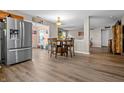 Open dining area featuring a wood table with seating for four and stainless steel refrigerator nearby at 2730 Foxbriar Pl, Indianapolis, IN 46203