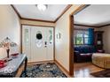 Inviting entryway with decorative glass door, patterned rug, and hardwood flooring leading into the living area at 2971 N Buck Creek Rd, Greenfield, IN 46140