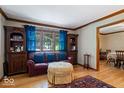 Bright living room featuring hardwood floors, a comfortable sofa, and views to the dining area at 2971 N Buck Creek Rd, Greenfield, IN 46140