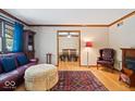 Cozy living room with hardwood floors, leather sofa, and fireplace, offering a warm and inviting atmosphere at 2971 N Buck Creek Rd, Greenfield, IN 46140