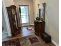 Elegant foyer with hardwood floors, a grandfather clock, and decorative accents at 308 Bay Ridge Dr, Pendleton, IN 46064