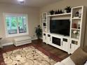 Inviting living room featuring custom built-ins, a large window, and a comfortable seating area at 308 Bay Ridge Dr, Pendleton, IN 46064