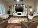 Comfortable living room with a large entertainment center and plush seating, perfect for relaxation at 308 Bay Ridge Dr, Pendleton, IN 46064