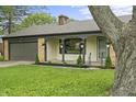 Charming brick home with an attached garage and inviting covered front porch at 3526 Westfield Dr, Anderson, IN 46011