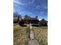 Exterior view of a cozy home with a spacious backyard and a trampoline for recreation at 3752 N Oxford St, Indianapolis, IN 46218