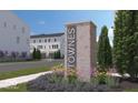 New development signage with brick base and manicured flower beds at 412 Elite St # 2-601, Westfield, IN 46074