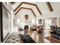 Spacious living room featuring beamed ceilings, hardwood floors, and a cozy fireplace at 4435 E 38Th St, Indianapolis, IN 46218