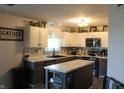 Well-lit kitchen with white cabinets, stainless steel appliances, and a center island at 5101 W Bay Rd, Plainfield, IN 46168