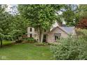 Two-story home featuring mature trees and a spacious yard with lush lawn and landscape design at 5412 Green Hills Dr, Brownsburg, IN 46112