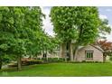 Two-story home boasts lush lawn and mature trees adding privacy and curb appeal to this beautiful property at 5412 Green Hills Dr, Brownsburg, IN 46112
