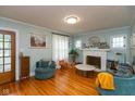 Cozy living room featuring hardwood floors and a fireplace at 5616 Winthrop Ave, Indianapolis, IN 46220