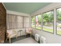 Bright sunroom with large windows offering pleasant outdoor views at 5616 Winthrop Ave, Indianapolis, IN 46220