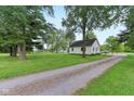 Inviting home with a long gravel driveway and spacious front yard at 6012 S 625 W, Pendleton, IN 46064