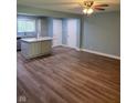 Open-concept living area with wood floors, connecting to a kitchen with a center island at 6117 Marilyn Rd, Indianapolis, IN 46226
