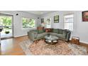 Bright living room featuring hardwood floors, corner sofa, and large windows at 6187 Crittenden Ave, Indianapolis, IN 46220