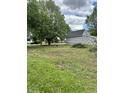 View of an under-construction home sitting on a lush green lot with mature trees at 6326 N Main St, Wilkinson, IN 46186