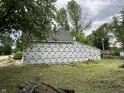View of an under-construction home featuring a lush green yard and mature trees at 6326 N Main St, Wilkinson, IN 46186