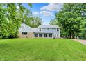 Beautiful home exterior with green lawn and long driveway at 6430 E Southport Rd, Indianapolis, IN 46237