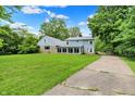 Beautiful home exterior with green lawn and long driveway at 6430 E Southport Rd, Indianapolis, IN 46237