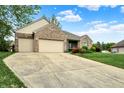 Brick home with a large driveway and two-car garage at 7310 Monaghan Ln, Indianapolis, IN 46217
