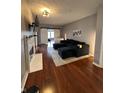 Spacious living room featuring a fireplace, TV, dark blue sectional sofa, and sliding barn doors at 7601 Newport Bay Dr # 203, Indianapolis, IN 46240