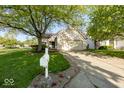 Attractive single-Gathering home with a two car garage, a mailbox, and a lush front lawn at 7650 Micawber Ct, Indianapolis, IN 46256