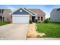 Beautiful brick and siding home with a two-car garage and fresh landscaping at 7918 Wolfgang Pl, Indianapolis, IN 46239