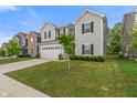 View of the home's exterior with a two car garage, neat landscaping, and a sidewalk at 918 Cass Dr, Franklin, IN 46131