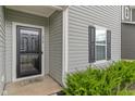 Close-up of the front door with gray siding, black shutters, and a welcome mat at 918 Cass Dr, Franklin, IN 46131