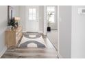 Bright entryway with a modern rug, stylish console table, and wood-look flooring at 9369 Casey Rd, Pendleton, IN 46064