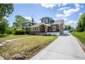 Inviting two-story home featuring manicured lawn, private drive, and traditional brick architecture at 949 E Southern Ave, Indianapolis, IN 46203