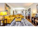 Bright living room showcasing a plush yellow sofa, unique artwork, and stylish décor at 949 E Southern Ave, Indianapolis, IN 46203