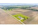 Expansive aerial view of the property showcasing the house nestled amidst farmland and lush greenery at 9605 W 100 S, Jamestown, IN 46147