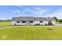 Inviting single-story home featuring a manicured lawn, complemented by an American flag for a patriotic touch at 9605 W 100 S, Jamestown, IN 46147