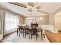 Elegant dining room featuring a coffered ceiling, modern chandelier, and a neutral color palette at 12437 Meeting House Rd, Carmel, IN 46032