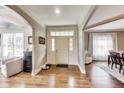 Inviting foyer with hardwood floors, crisp white trim, and a bright entrance with views to adjacent living spaces at 12437 Meeting House Rd, Carmel, IN 46032