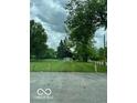 View of recently mowed Siratky Park with sign and surrounding trees and street at 1516 W 20Th W St, Anderson, IN 46016