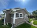 Angle view of this charming single-Gathering home with light brown siding, a cozy space to make yours! at 1527 Main St, Beech Grove, IN 46107