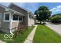 Side-angle shot of the single-Gathering home, featuring tidy landscaping and street view at 1527 Main St, Beech Grove, IN 46107