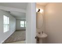 Cozy powder room featuring a pedestal sink, oval mirror, and neutral paint at 163 Clear Branch Dr, Brownsburg, IN 46112