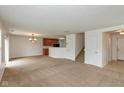 Open living space with carpet, stairs, and an adjacent kitchen area at 163 Clear Branch Dr, Brownsburg, IN 46112