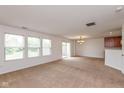 Spacious living room featuring neutral carpet, large windows, and a dining area at 163 Clear Branch Dr, Brownsburg, IN 46112