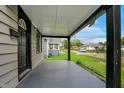 View of the covered front porch showcasing dark support beams and views of the surrounding neighborhood at 1722 Dawson St, Indianapolis, IN 46203