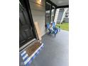 Charming front porch showcasing a blue and white welcome mat and blue Adirondack chairs at 1722 Dawson St, Indianapolis, IN 46203