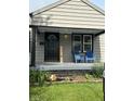 Inviting front porch with blue Adirondack chairs and charming decor at 1722 Dawson St, Indianapolis, IN 46203